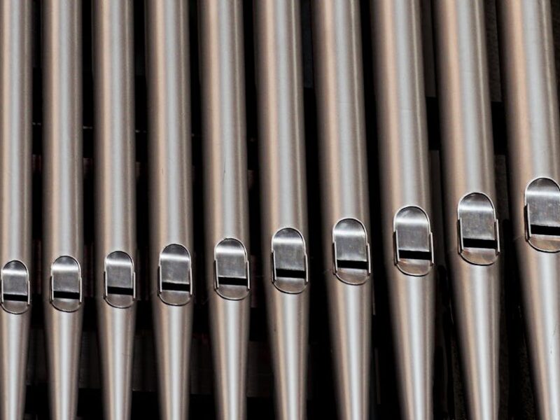 organ-pipes-church-music-161111 Close-up of metallic organ pipes showcasing vintage design and harmony.